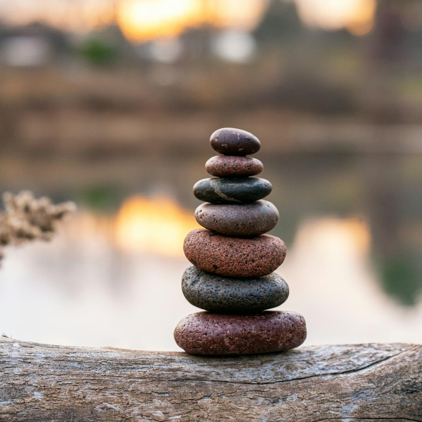brown stone stack on brown wooden log